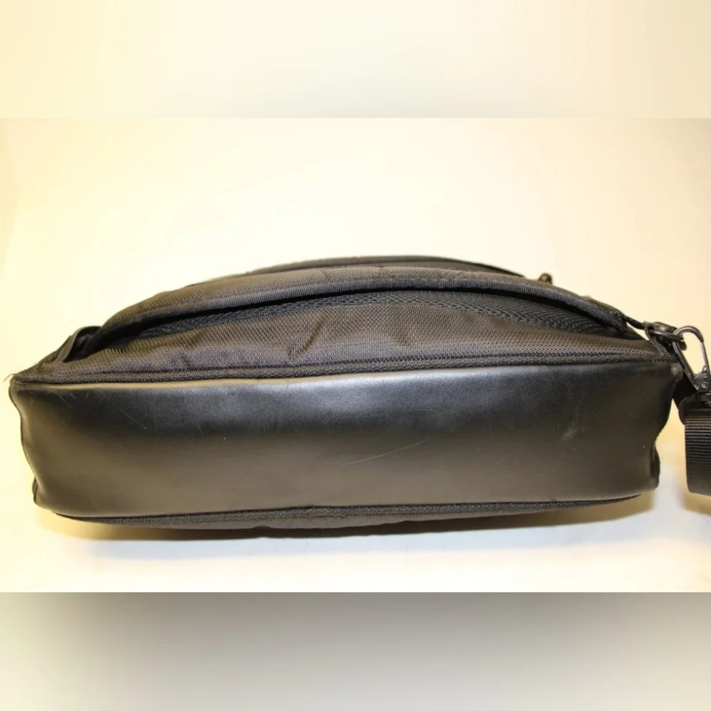 TUMI Black Backpack with Padded Straps and Multiple Compartments
